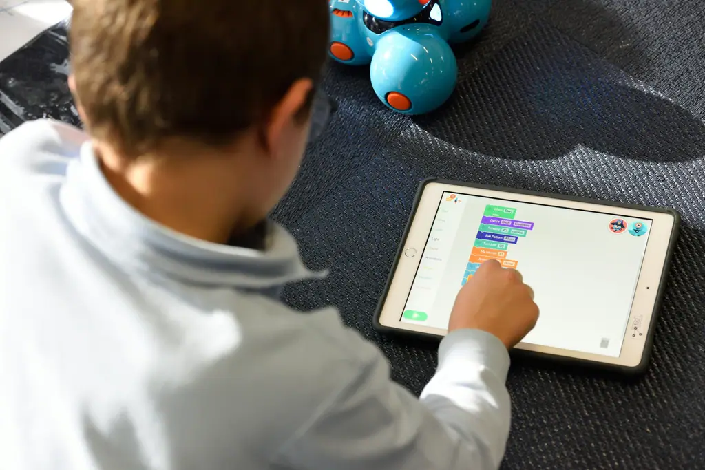 A child using a learning app on a tablet.